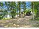 View of backyard showing elevated house with screened-in back porch at 183 Wynnmeade, Peachtree City, GA 30269