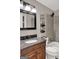 Bathroom featuring granite countertops, framed mirror, and tiled shower at 183 Wynnmeade, Peachtree City, GA 30269