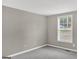 Spare bedroom with light gray walls, carpet and a view through the window at 183 Wynnmeade, Peachtree City, GA 30269