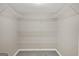 Empty walk-in closet with plenty of shelving and soft carpet at 183 Wynnmeade, Peachtree City, GA 30269