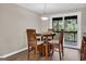 Cozy dining area featuring a round table with seating for four and a sliding glass door to the outside at 183 Wynnmeade, Peachtree City, GA 30269