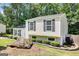 Pleasant home with attractive landscaping and a unique boulder feature enhancing the outdoor aesthetics at 183 Wynnmeade, Peachtree City, GA 30269