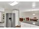 Bright kitchen with stainless steel fridge and view into the dining room with a round wood table at 183 Wynnmeade, Peachtree City, GA 30269
