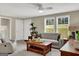 Inviting living room featuring a comfortable couch, coffee table, and ample natural light from large windows at 183 Wynnmeade, Peachtree City, GA 30269