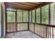 View of the screened-in porch with wooded views and lattice design at 183 Wynnmeade, Peachtree City, GA 30269