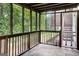 Covered screened-in porch with wooded views, and wooden rails at 183 Wynnmeade, Peachtree City, GA 30269