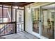 View of the screened-in porch with sliding glass door into the dining area, and stairs leading to the backyard at 183 Wynnmeade, Peachtree City, GA 30269