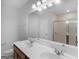 Bathroom featuring double vanity sinks, a large mirror, and a glass door shower at 505 Mariposa Ln, Mcdonough, GA 30253