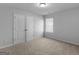 Cozy bedroom showcasing plush carpet, a double-door closet, and a bright window at 505 Mariposa Ln, Mcdonough, GA 30253