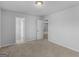 Neutral bedroom featuring soft carpet, a light fixture, and doorways to other rooms at 505 Mariposa Ln, Mcdonough, GA 30253