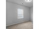 Neutral bedroom featuring a window and carpeted floors at 505 Mariposa Ln, Mcdonough, GA 30253