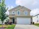 Charming two-story home with a two-car garage, manicured lawn and inviting curb appeal at 505 Mariposa Ln, Mcdonough, GA 30253