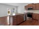 Modern kitchen with stainless steel appliances, granite countertops, island and hardwood floors at 505 Mariposa Ln, Mcdonough, GA 30253