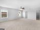 Spacious main bedroom with natural light, neutral carpet, and large windows at 505 Mariposa Ln, Mcdonough, GA 30253