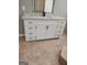 Bathroom vanity features granite counters, white cabinets and black hardware at 2587 Mead Ct, Jonesboro, GA 30236
