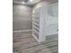 Walk-in closet with custom shelving and new wood flooring at 2587 Mead Ct, Jonesboro, GA 30236