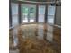 Sunlit dining area with beautiful tile floors, stylish lighting fixture, and patio doors to the deck at 2587 Mead Ct, Jonesboro, GA 30236