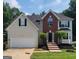 Charming two-story home boasts a manicured lawn, brick accents, and an attached two-car garage at 2587 Mead Ct, Jonesboro, GA 30236