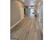 Hallway featuring modern flooring leading to an outdoor entryway and multiple doorways at 2587 Mead Ct, Jonesboro, GA 30236