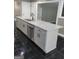 Gourmet kitchen featuring stainless steel appliances, island sink, and ample cabinet space at 2587 Mead Ct, Jonesboro, GA 30236