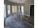 Bright room with large windows and new flooring, ladder in the middle of the room at 2587 Mead Ct, Jonesboro, GA 30236