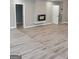 Beautiful living room with wood flooring, a fireplace, and updated lighting at 2587 Mead Ct, Jonesboro, GA 30236
