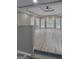 Living room showcases a ceiling fan, large windows, and light-colored wood flooring at 2587 Mead Ct, Jonesboro, GA 30236