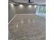 Bright living room featuring recessed lighting, large windows, and tile wood-patterned floors at 2587 Mead Ct, Jonesboro, GA 30236