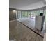 Open-plan room with new wood-look tile flooring, surrounded by large windows, and a glass patio door at 2587 Mead Ct, Jonesboro, GA 30236