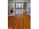 Spacious living room with refinished hardwood floors, a fireplace, and bay windows at 2587 Mead Ct, Jonesboro, GA 30236