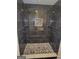 Modern shower with dark marble tile and a decorative mosaic accent shelf at 2587 Mead Ct, Jonesboro, GA 30236