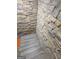 Stairwell featuring beautiful stone accent walls and gray wood-look floors at 2587 Mead Ct, Jonesboro, GA 30236