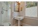 Bathroom with pedestal sink, framed mirror and a view of a glass enclosed shower at 53 Born St, Norcross, GA 30071
