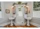 Bathroom featuring a glass enclosed shower with double vanities and wall sconces at 53 Born St, Norcross, GA 30071