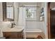 Charming bathroom featuring a clawfoot tub, marble vanity, and decorative mirror at 53 Born St, Norcross, GA 30071