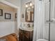 Bathroom with wood floors, marble vanity, beadboard wainscoting, and stylish fixtures at 53 Born St, Norcross, GA 30071