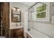 Vintage-style bathroom showcasing a soaking tub under a window and an ornate vanity at 53 Born St, Norcross, GA 30071