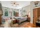 Bedroom featuring a large bed, ceiling fan, fireplace and seating at 53 Born St, Norcross, GA 30071
