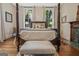 Bedroom showcasing a four-poster bed and a decorative fireplace, combining classic charm and comfort at 53 Born St, Norcross, GA 30071