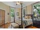 Bedroom features a four-poster bed, hardwood floors, and multiple windows for natural light at 53 Born St, Norcross, GA 30071
