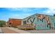 Exterior of building featuring a colorful mural, brick facade and a cozy outdoor deck at 53 Born St, Norcross, GA 30071