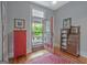 Sunroom entry featuring painted cabinet and wood hutch on wood floors with an exterior screened door at 53 Born St, Norcross, GA 30071