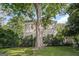 Charming two-story home with a swing hanging from a large tree in the front yard at 53 Born St, Norcross, GA 30071