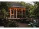 Exterior view of a charming home with a screened-in porch and string lights at 53 Born St, Norcross, GA 30071