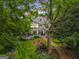 Charming two-story home with a sprawling porch and manicured lawn and garden at 53 Born St, Norcross, GA 30071