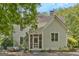 Two-story home features a screened-in porch and lush greenery at 53 Born St, Norcross, GA 30071