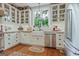 Beautiful kitchen features white cabinets, stainless appliances, and an oval rug at 53 Born St, Norcross, GA 30071