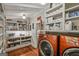 Functional laundry room with bright red washer and dryer, and ample storage at 53 Born St, Norcross, GA 30071