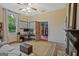 This well-lit living room includes hardwood floors, two windows, and a workspace with dual monitors at 53 Born St, Norcross, GA 30071