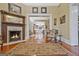 Spacious living room features a fireplace, hardwood floors, and an open doorway to the kitchen at 53 Born St, Norcross, GA 30071